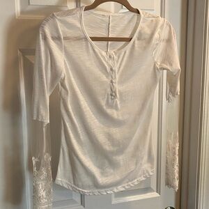 White Henley with Lace / Sheer Sleeve. Lace & Mesh on the lower back.